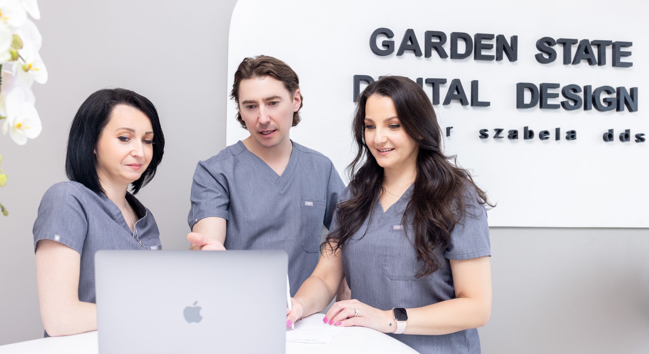 clark biologic dentistry staff looking at laptop