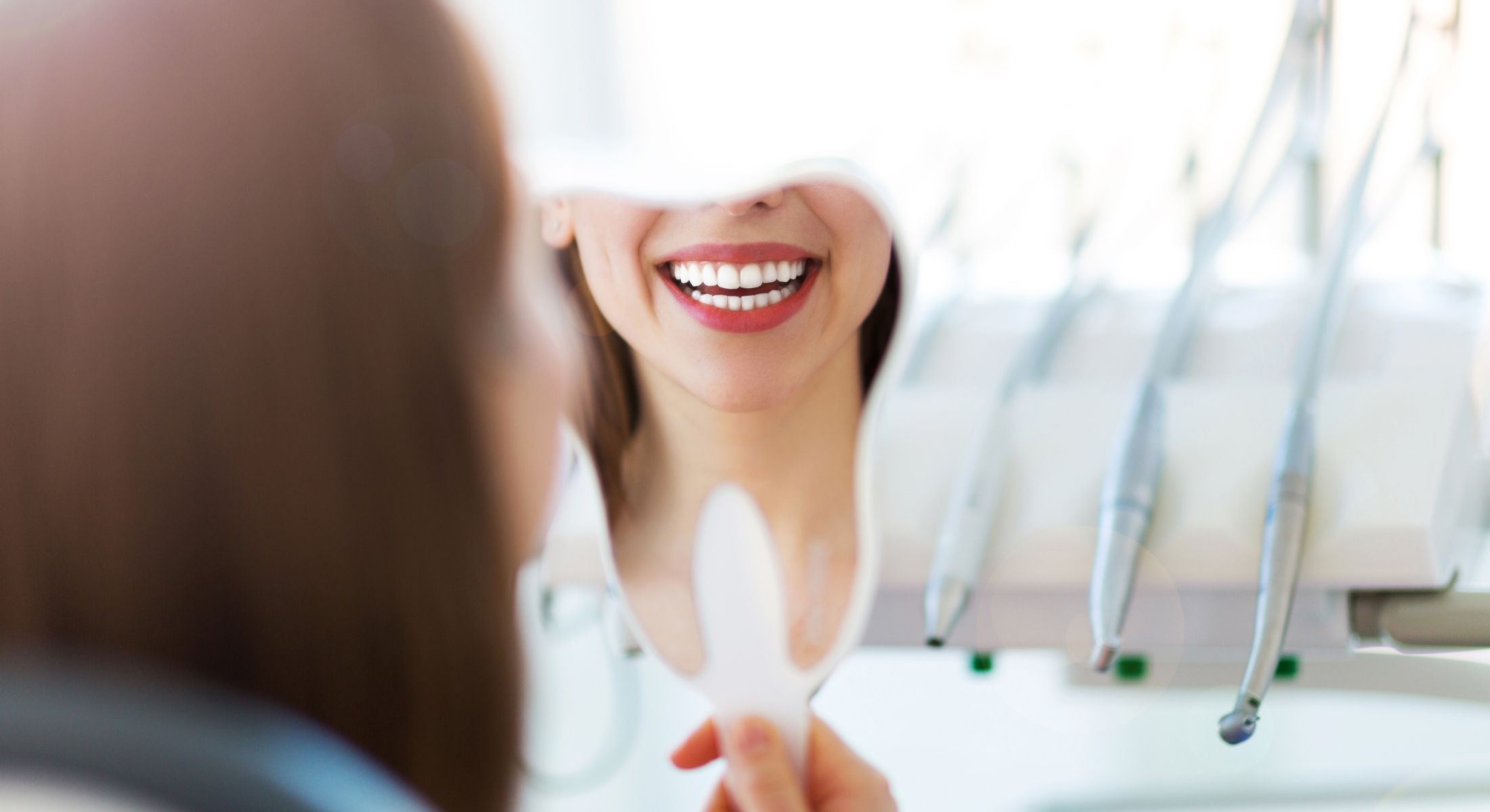 clark cosmetic dentistry model smiling in mirror